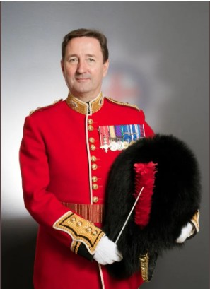 Graham in ceremonial uniform with his medals, holding his bearskin